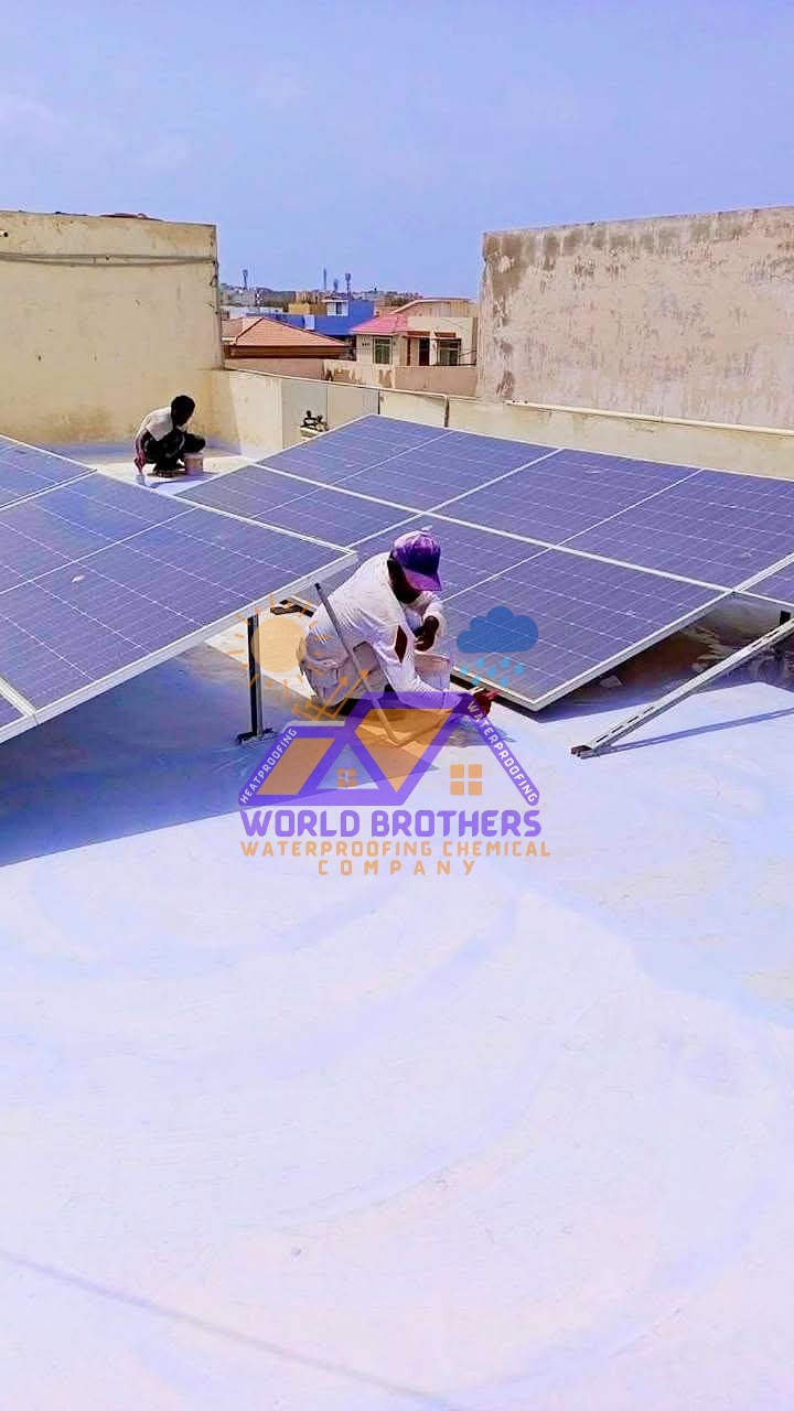 Worker applying heat proofing coating on a residential rooftop